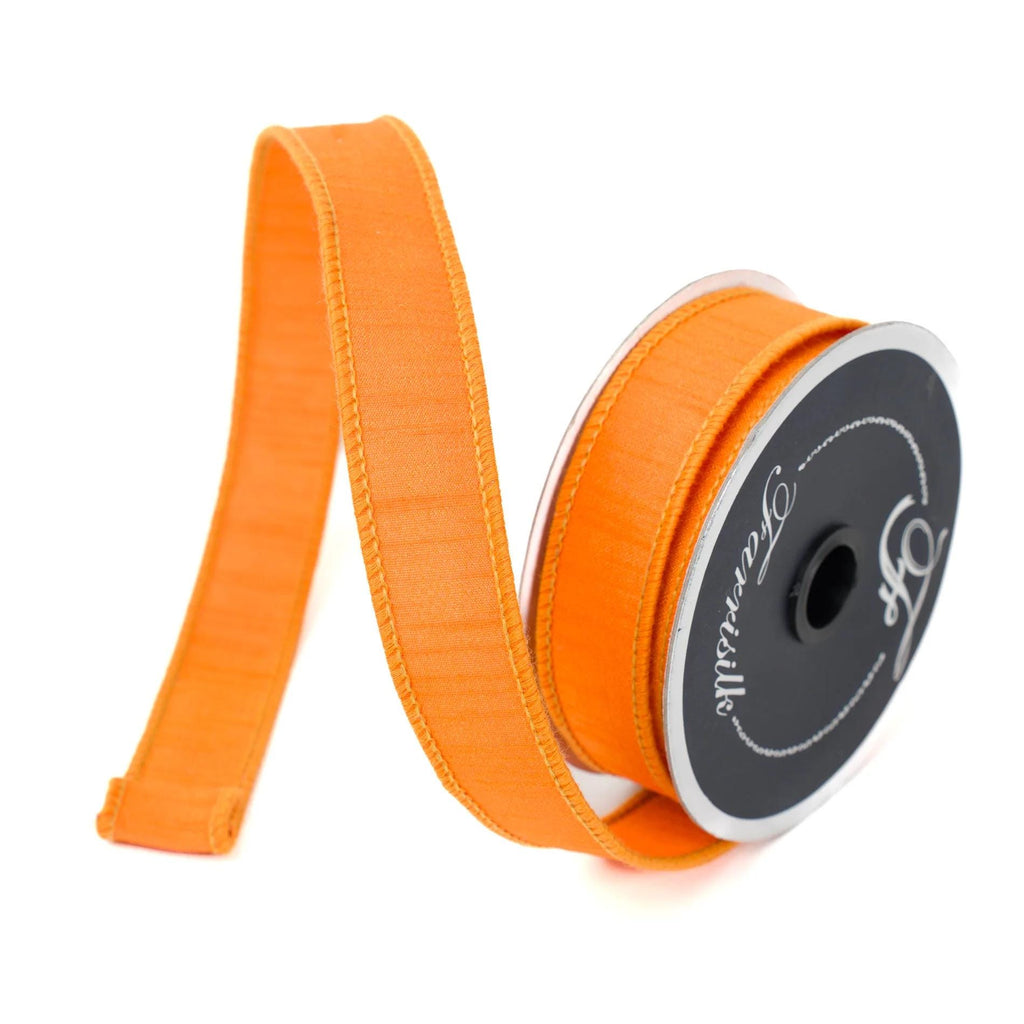 Orange dupioni wired ribbon unrolled on spool for bow making and fall crafts.